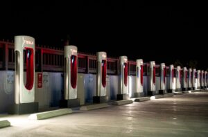 Multi-car electric vehicle charging station showcasing fast charging capabilities for various models on the road. 