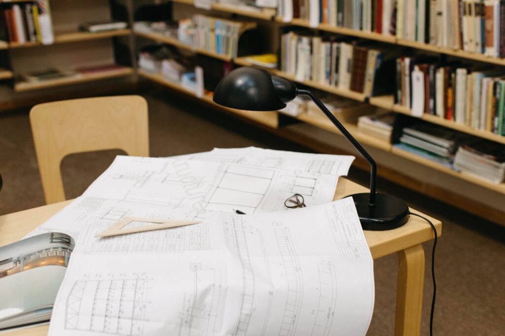 An engineering drawing of solar panels designs with a backdrop of a library filled with books and resources related to solar energy and sustainable technologies.