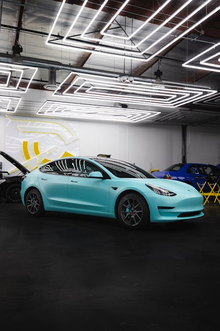 A sleek electric car showcased in a stylish indoor garage setting under geometric lighting.