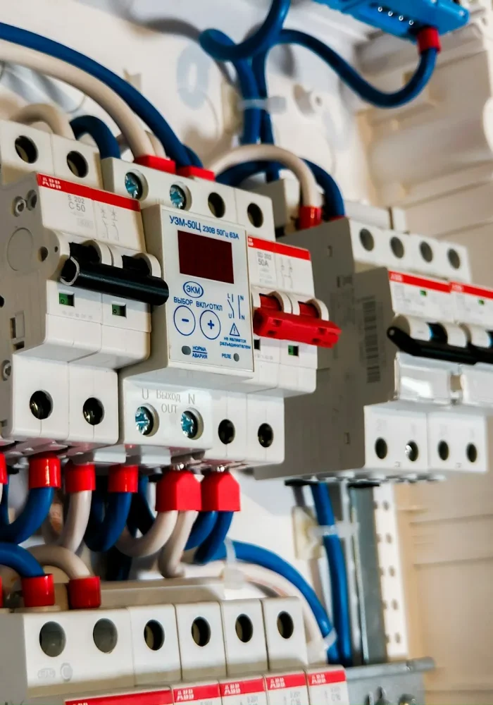 Electrical_Installation3 DrBuild team installing circuit breakers in an electrical panel during a commercial project.